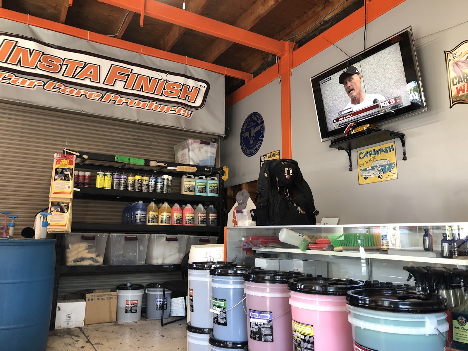 Shop interior showing Insta Finish car care products and detailing supplies